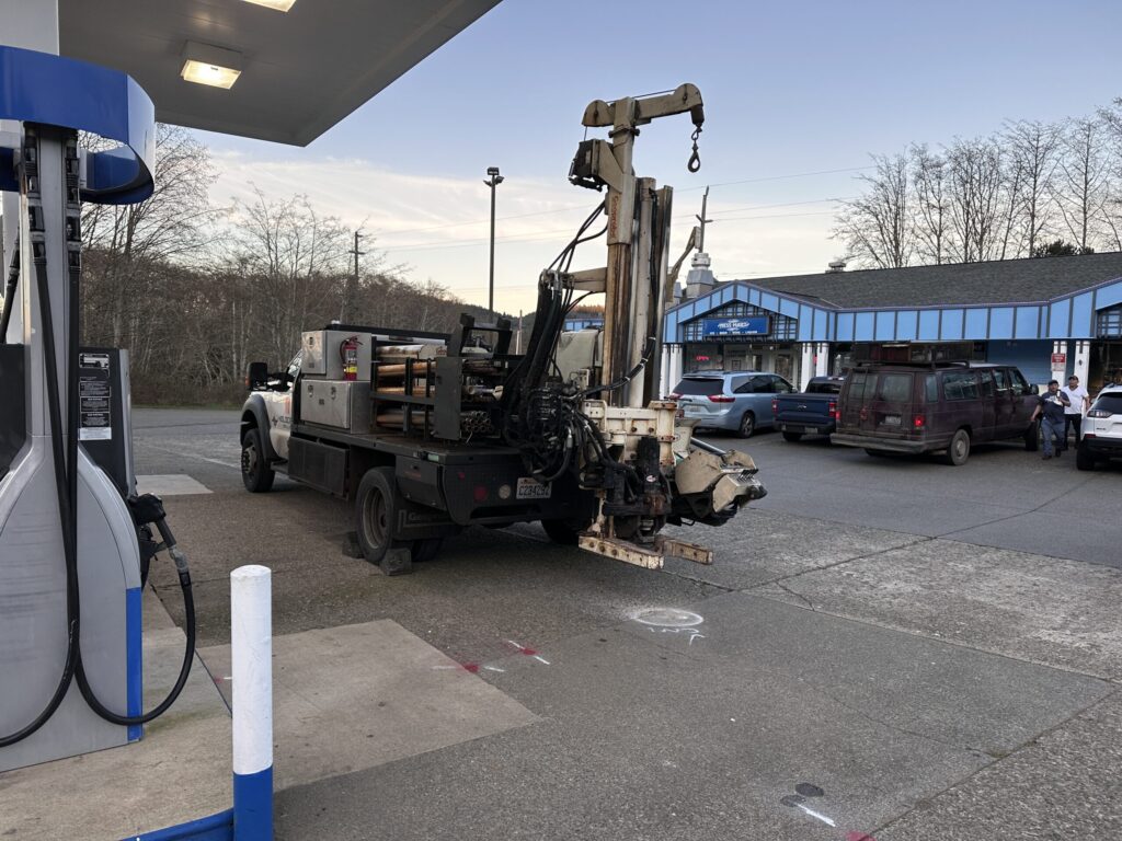 Geoprobe drilling rig truck conducting a Phase II ESA subsurface soil investigation at a historical gas station in Fayetteville, Arkansas.